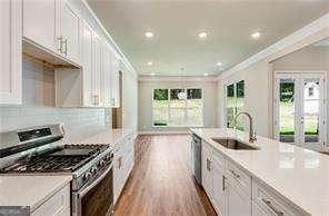 kitchen featuring a sink, plenty of natural light, crown molding, and appliances with stainless steel finishes