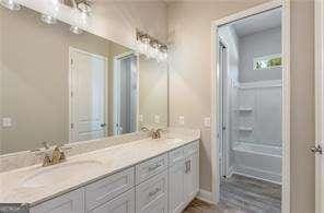 bathroom featuring double vanity and a sink