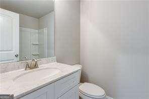 bathroom with toilet and vanity
