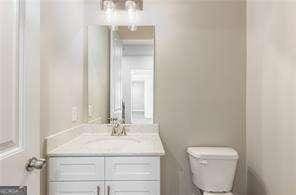 bathroom featuring toilet and vanity