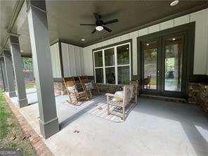 view of patio / terrace with french doors, ceiling fan, and a porch