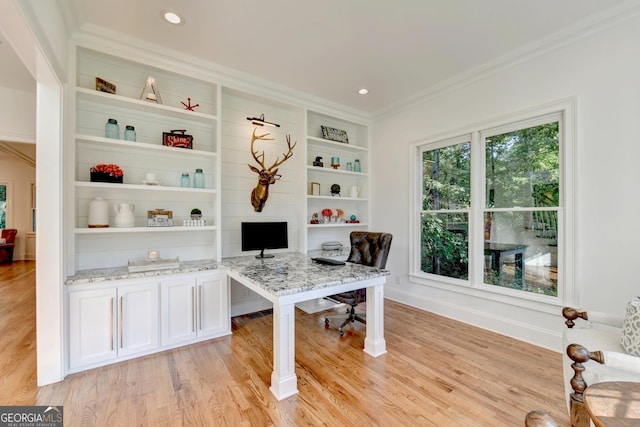 office area featuring ornamental molding, built in features, and light wood-type flooring