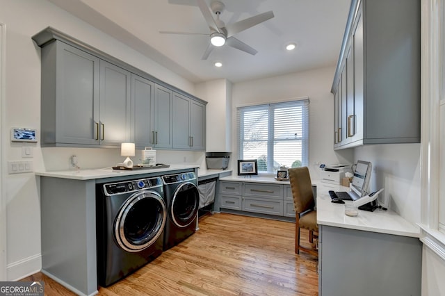 laundry area featuring light hardwood / wood-style floors, washing machine and dryer, cabinets, and ceiling fan