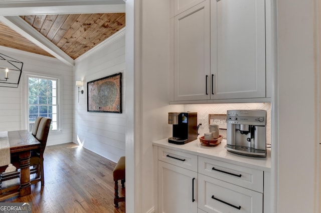 bar with crown molding, wood ceiling, backsplash, dark hardwood / wood-style floors, and white cabinets