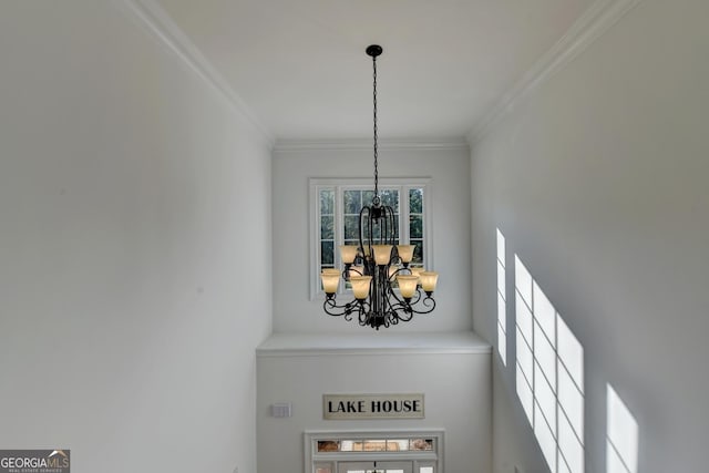 details featuring crown molding and an inviting chandelier