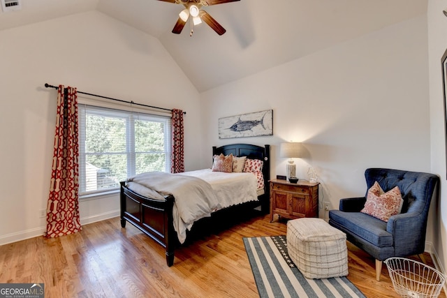 bedroom featuring hardwood / wood-style floors, vaulted ceiling, and ceiling fan