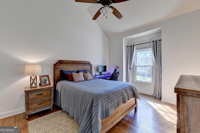 bedroom featuring hardwood / wood-style flooring, vaulted ceiling, and ceiling fan