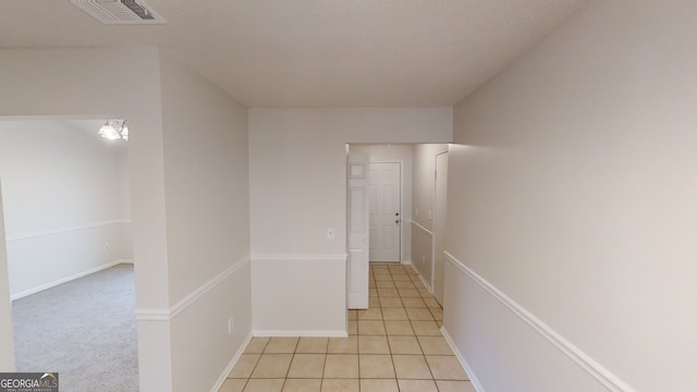 hall featuring light tile patterned floors