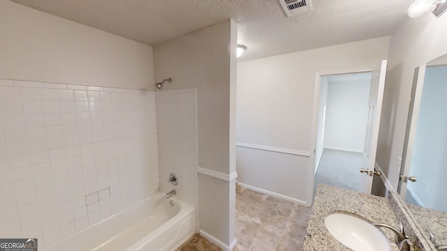 bathroom with vanity, a textured ceiling, and shower / bath combination