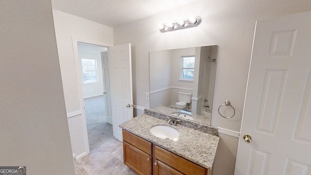 bathroom with vanity, plenty of natural light, and toilet