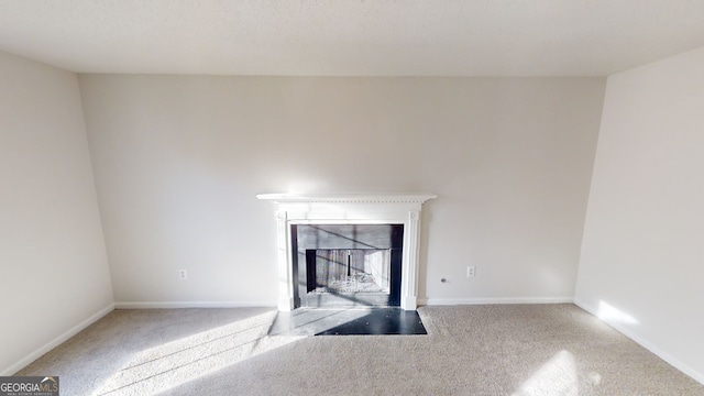 unfurnished living room featuring carpet