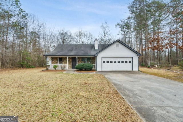 view of front of property featuring a porch, a garage, and a front lawn