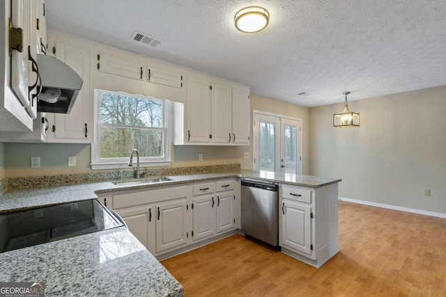 kitchen with pendant lighting, sink, white cabinets, stainless steel dishwasher, and light stone counters