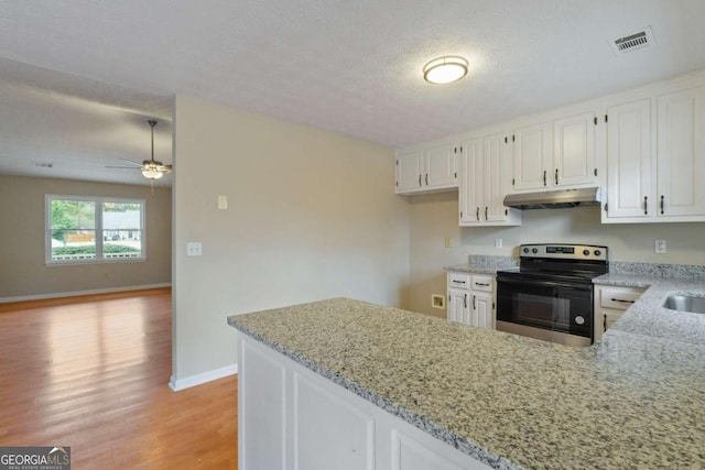 kitchen featuring white cabinetry, light stone counters, black electric range, light hardwood / wood-style flooring, and kitchen peninsula