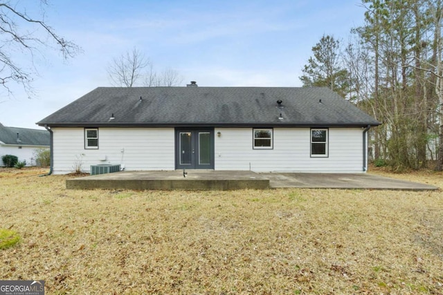 rear view of property featuring a yard, a patio, and central air condition unit