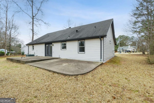 rear view of property with a lawn and a patio area