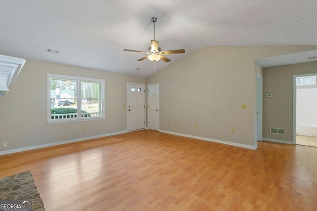 unfurnished living room with vaulted ceiling, ceiling fan, and light hardwood / wood-style flooring