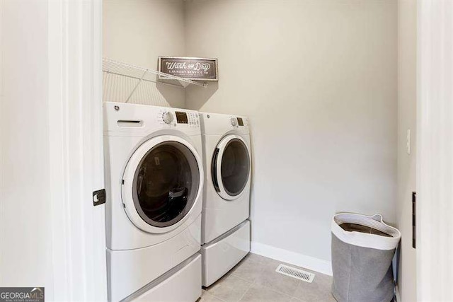 washroom with light tile patterned floors and independent washer and dryer