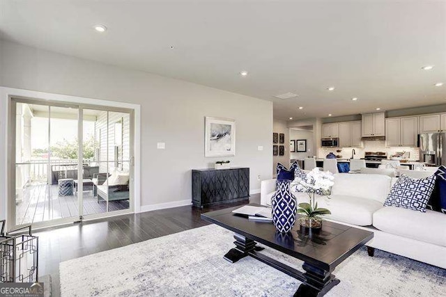 living room with dark hardwood / wood-style flooring