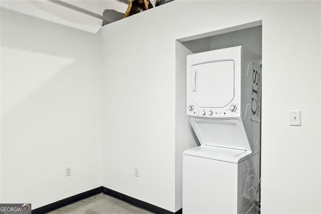 washroom featuring stacked washer and clothes dryer