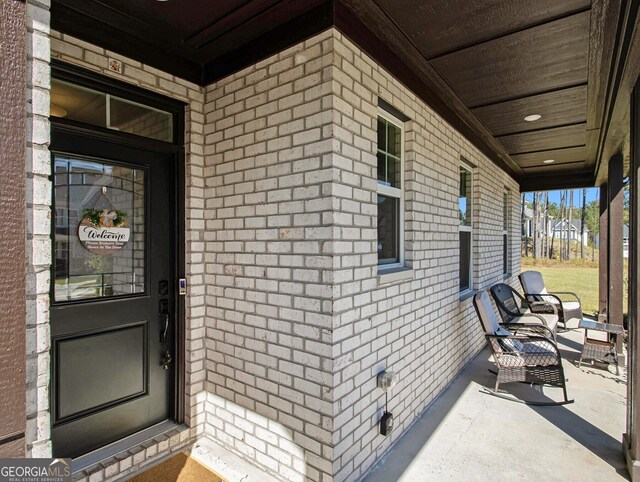 view of exterior entry with a porch