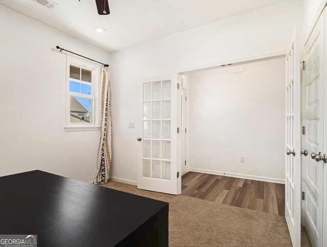 interior space with carpet floors and ceiling fan