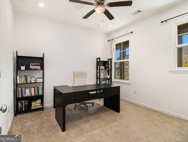 carpeted home office with ceiling fan