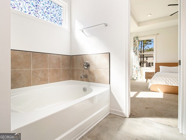 bathroom featuring tile patterned floors and a tub to relax in