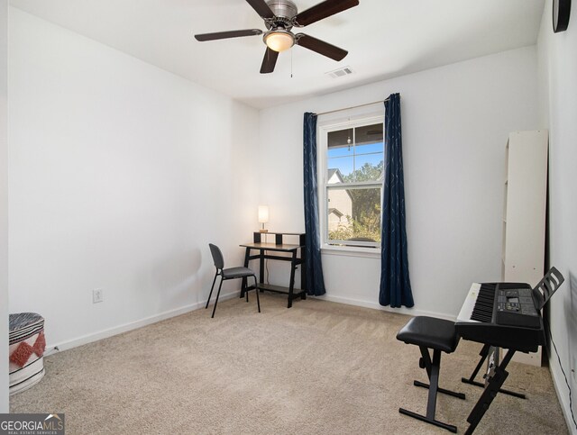 interior space featuring light carpet and ceiling fan