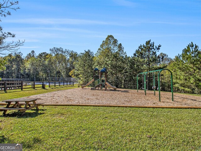 view of jungle gym with a lawn