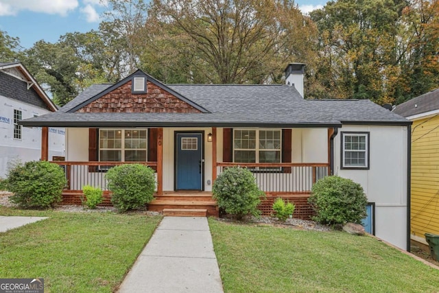 view of front of home with covered porch and a front yard