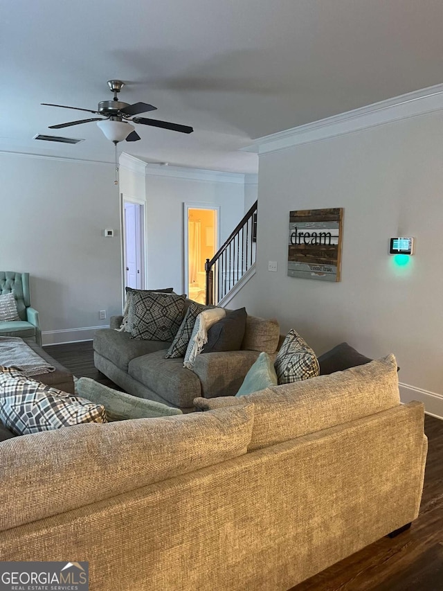 living room with crown molding, dark wood-type flooring, and ceiling fan