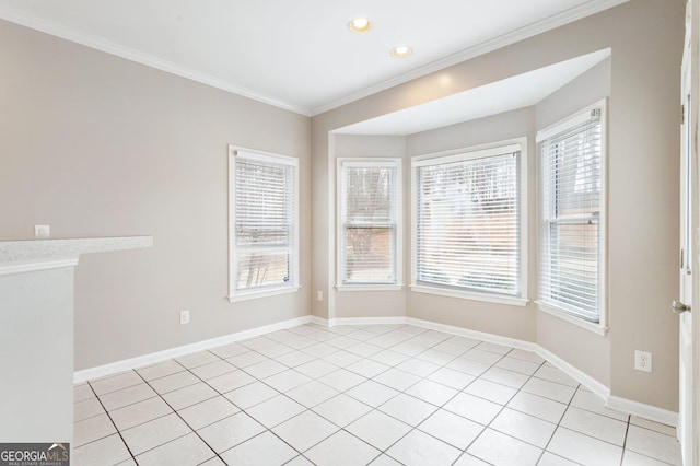 unfurnished room with light tile patterned floors, crown molding, and plenty of natural light