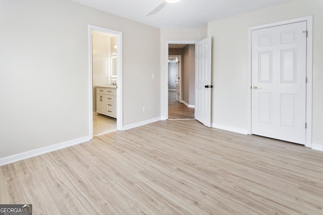 unfurnished bedroom with light hardwood / wood-style floors, ceiling fan, and ensuite bathroom