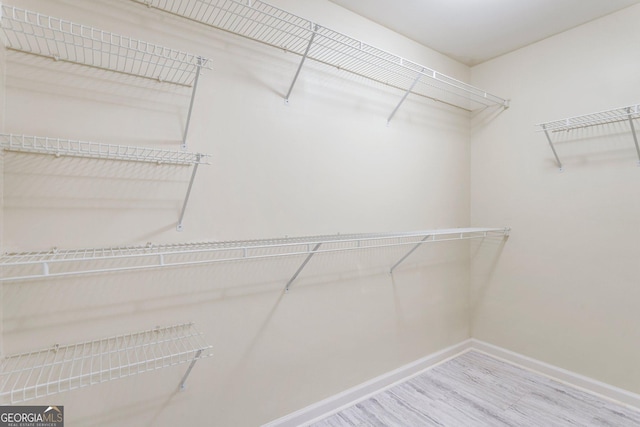 walk in closet featuring hardwood / wood-style floors