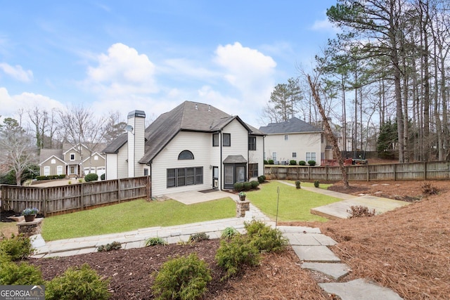 back of house with a patio and a yard