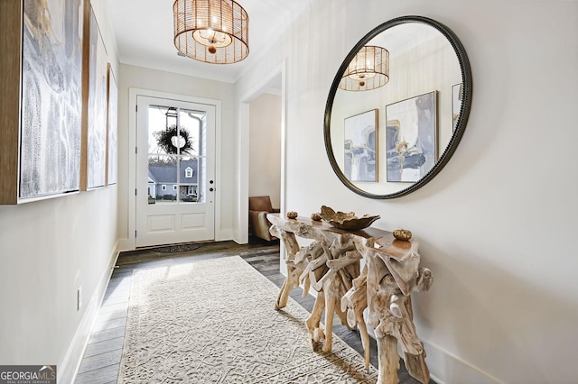 doorway featuring dark hardwood / wood-style floors and a chandelier