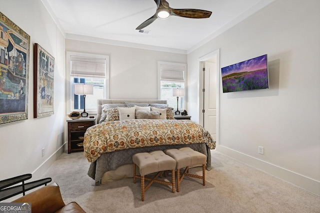 carpeted bedroom with crown molding and ceiling fan