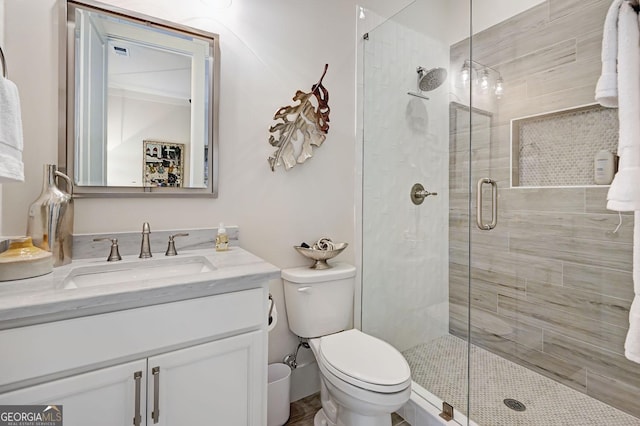 bathroom featuring vanity, toilet, and an enclosed shower