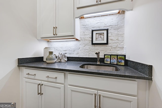 kitchen featuring sink and white cabinets