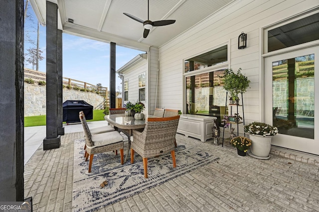 sunroom / solarium featuring ceiling fan