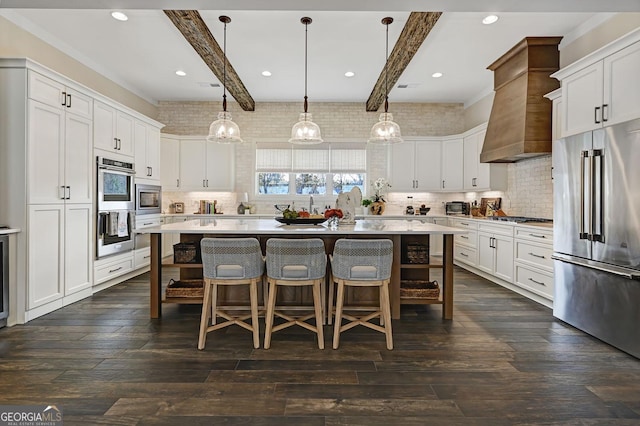 kitchen featuring appliances with stainless steel finishes, decorative light fixtures, and a kitchen island