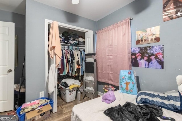 bedroom featuring hardwood / wood-style floors and a closet