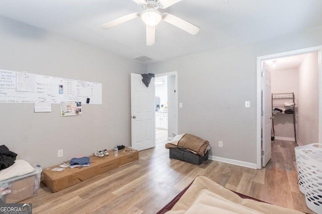 sitting room featuring light hardwood / wood-style floors and ceiling fan