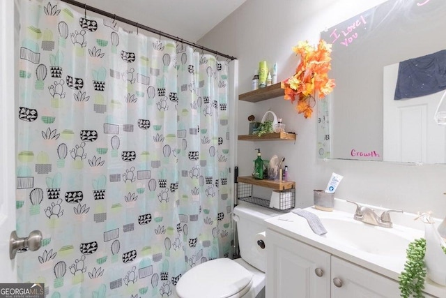 bathroom with vanity, a shower with shower curtain, and toilet