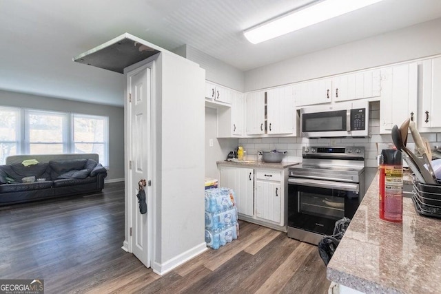 kitchen with white cabinetry, appliances with stainless steel finishes, dark hardwood / wood-style floors, and backsplash