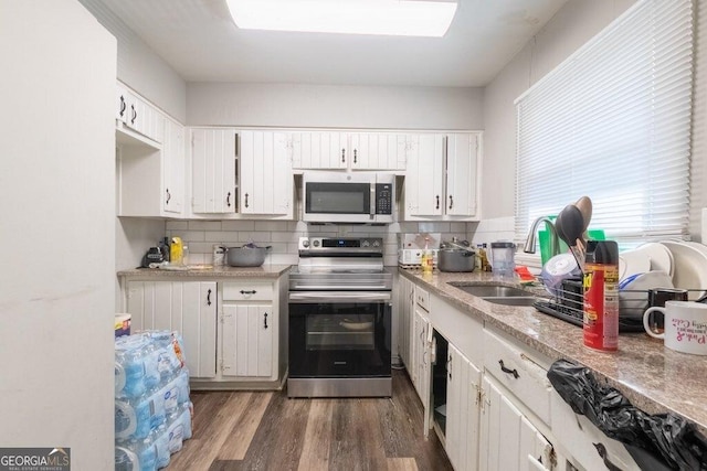 kitchen with sink, white cabinets, and appliances with stainless steel finishes