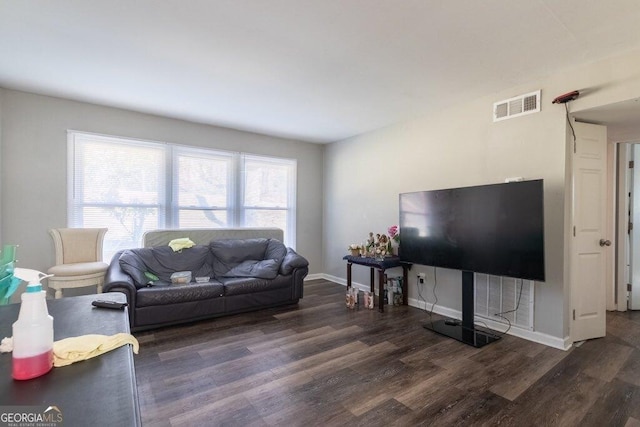 living room with dark hardwood / wood-style flooring