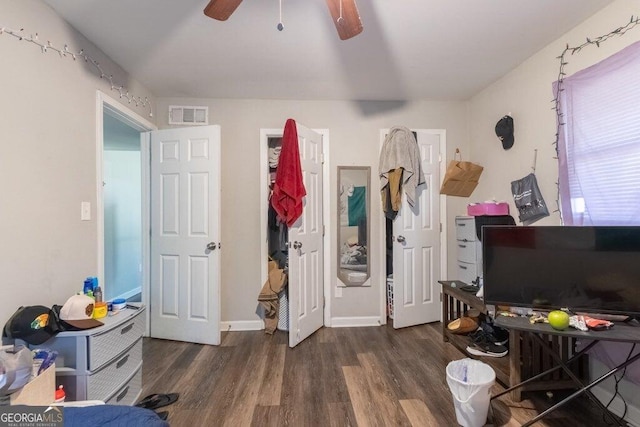 misc room with dark hardwood / wood-style floors and ceiling fan