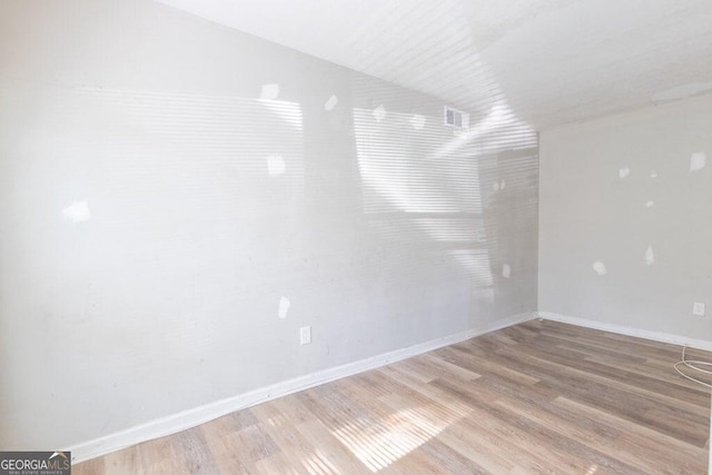 unfurnished room featuring light hardwood / wood-style floors